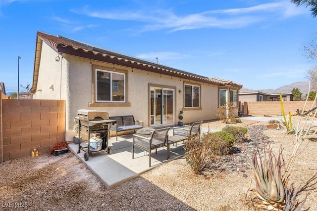 8140 Redbud Vine St, North Las Vegas, NV 89085 - rear view of house with a patio, a fenced backyard, stucco siding, and outdoor lounge area