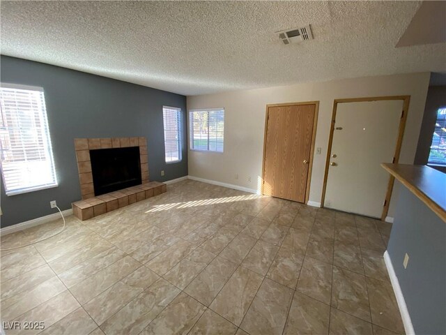 2685 Bryandouglas Dr, Las Vegas, NV 89121 - unfurnished living room with a textured ceiling, a fireplace, and baseboards