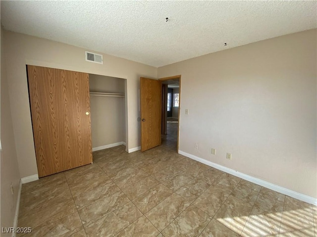 2685 Bryandouglas Dr, Las Vegas, NV 89121 - unfurnished bedroom featuring a closet, a textured ceiling, and baseboards