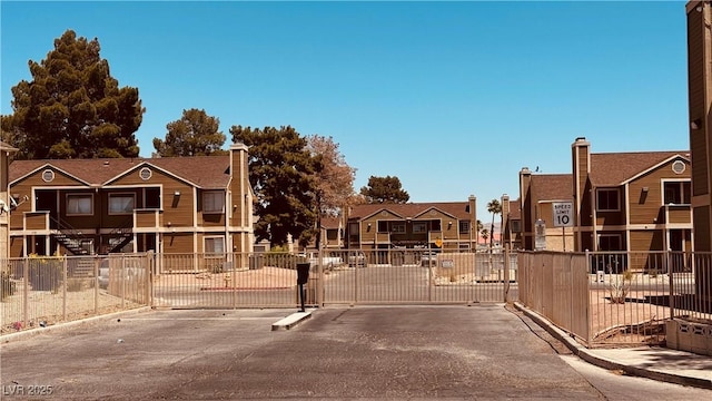 2685 Bryandouglas Dr, Las Vegas, NV 89121 - view of asphalt street with curbs, a gate, a gated entry, and a residential view