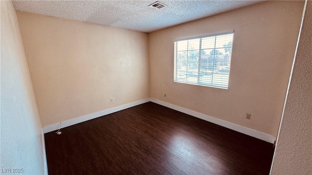 2685 Bryandouglas Dr, Las Vegas, NV 89121 - unfurnished room featuring dark wood-style floors, a textured ceiling, and baseboards