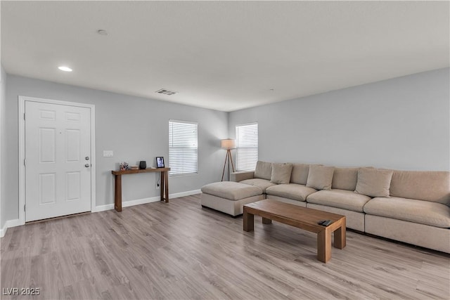 living area featuring recessed lighting, baseboards, visible vents, and light wood finished floors