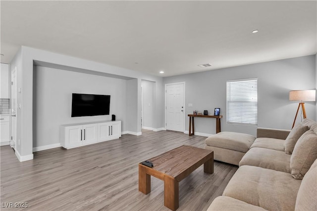 living room with baseboards, recessed lighting, light wood-style flooring, and visible vents