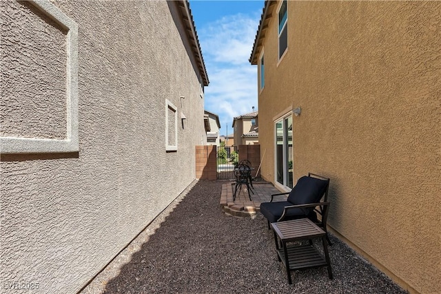 view of home's exterior with fence, a patio, and stucco siding