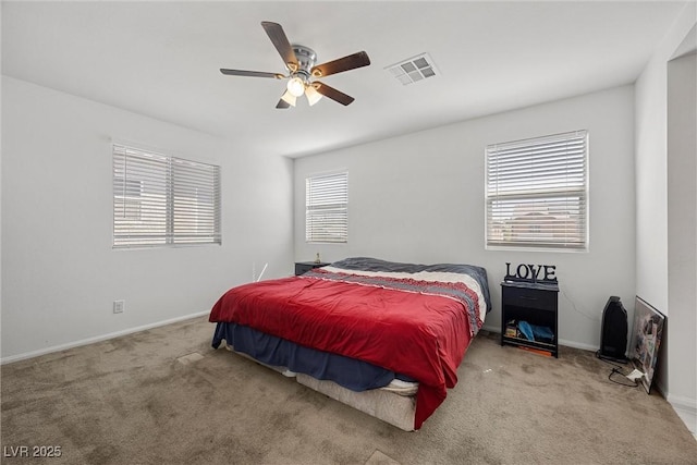 carpeted bedroom featuring baseboards, ceiling fan, and visible vents