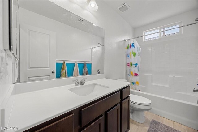 bathroom with shower / tub combo with curtain, vanity, toilet, and visible vents