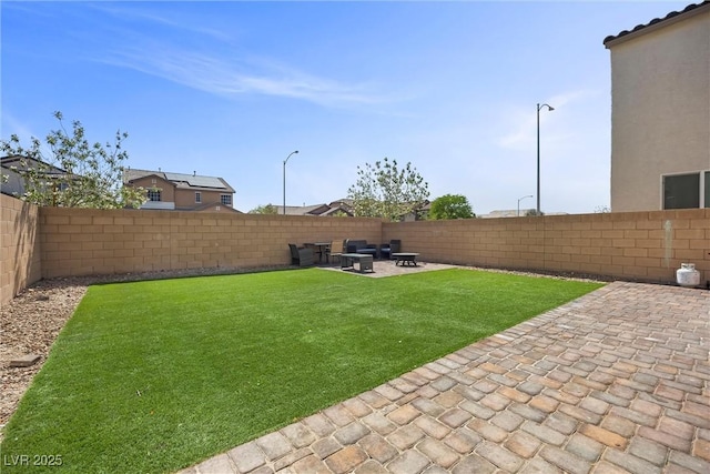 view of yard featuring a fenced backyard, a patio area, and an outdoor fire pit