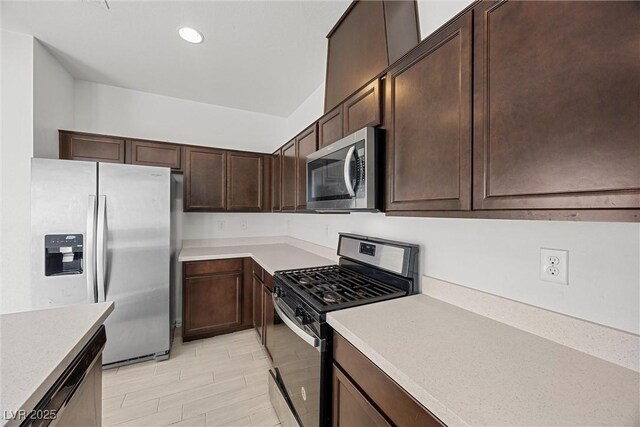 kitchen with light countertops, appliances with stainless steel finishes, dark brown cabinetry, and recessed lighting