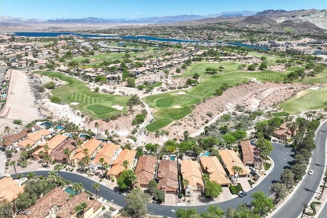drone / aerial view with a residential view, a mountain view, and golf course view