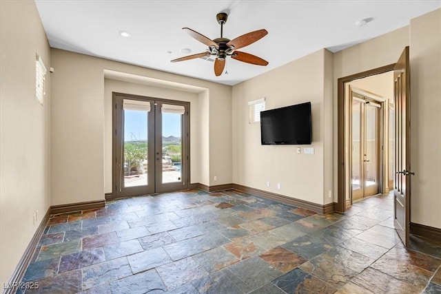 unfurnished living room featuring recessed lighting, stone tile floors, ceiling fan, baseboards, and french doors