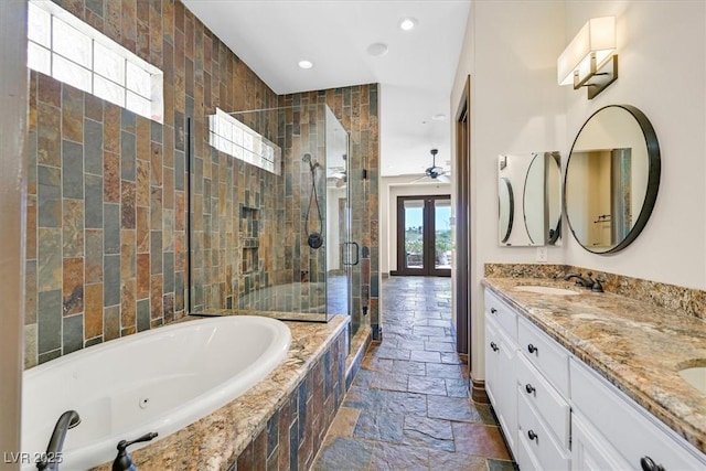 full bathroom with recessed lighting, a tub with jets, a shower stall, a sink, and stone tile floors