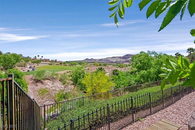 view of yard featuring a mountain view and fence