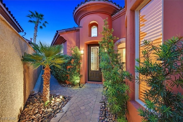 doorway to property with stucco siding