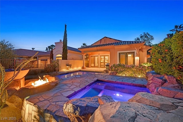 view of swimming pool featuring a patio, an outdoor fire pit, a fenced in pool, french doors, and fence