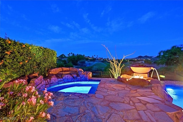 view of pool featuring fence, a patio area, an in ground hot tub, and a fenced in pool