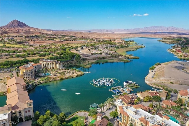 drone / aerial view with a water and mountain view