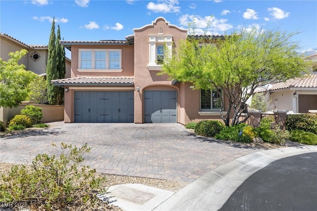 12254 Cape Cortez Ct, Las Vegas, NV 89138 - mediterranean / spanish-style house with stucco siding, decorative driveway, and an attached garage