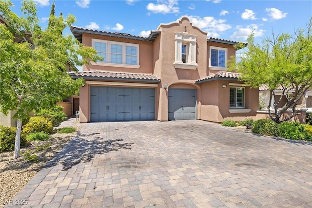 12254 Cape Cortez Ct, Las Vegas, NV 89138 - mediterranean / spanish home with a garage, stucco siding, a tile roof, and decorative driveway