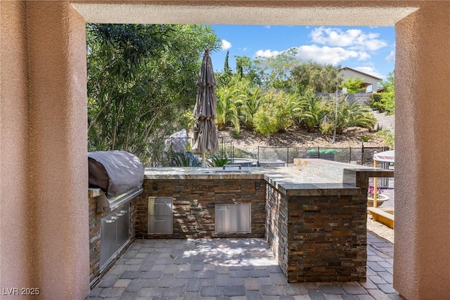 12254 Cape Cortez Ct, Las Vegas, NV 89138 - view of patio / terrace featuring grilling area, exterior kitchen, and fence