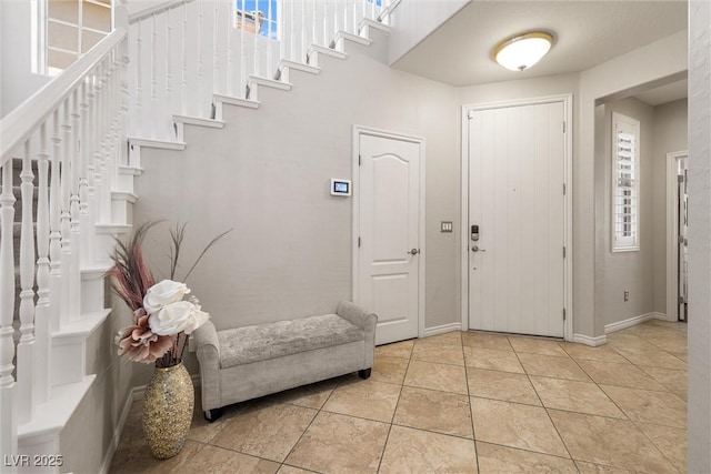 12254 Cape Cortez Ct, Las Vegas, NV 89138 - foyer entrance with light tile patterned floors, baseboards, and plenty of natural light