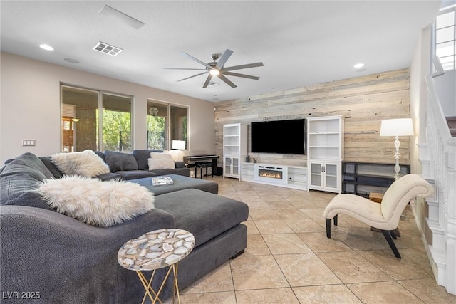 12254 Cape Cortez Ct, Las Vegas, NV 89138 - tiled living room with an accent wall, ceiling fan, wood walls, and plenty of natural light