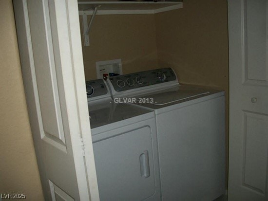 laundry room featuring separate washer and dryer and laundry area
