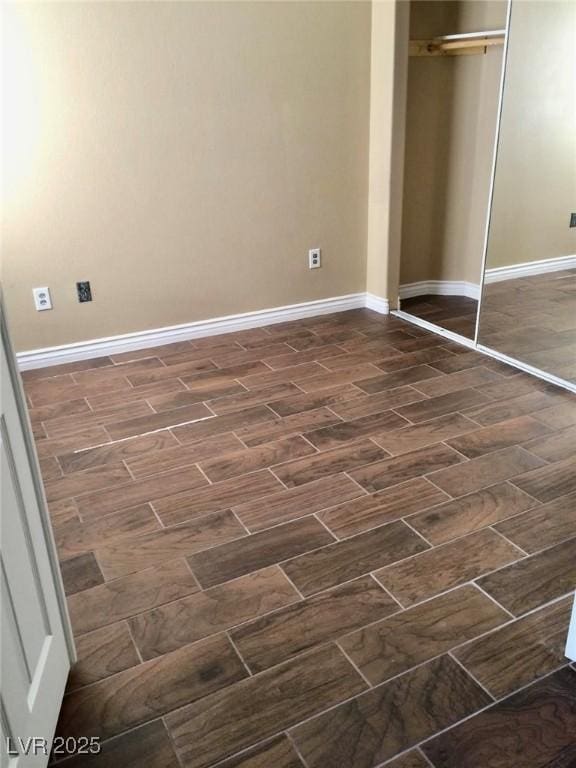 unfurnished bedroom with baseboards and a closet