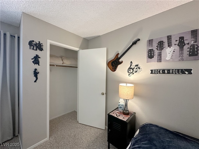 bedroom featuring a textured ceiling and carpet
