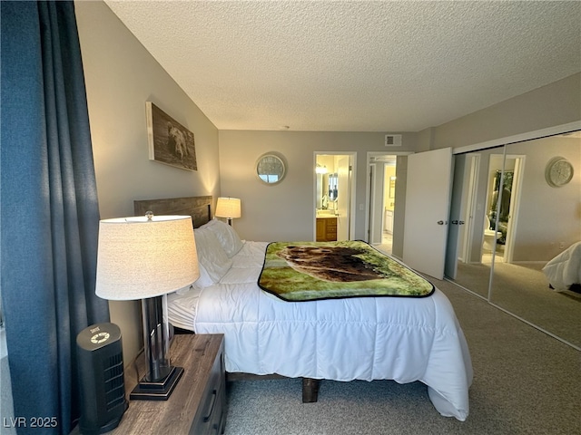 carpeted bedroom featuring visible vents, ensuite bath, a textured ceiling, and a closet