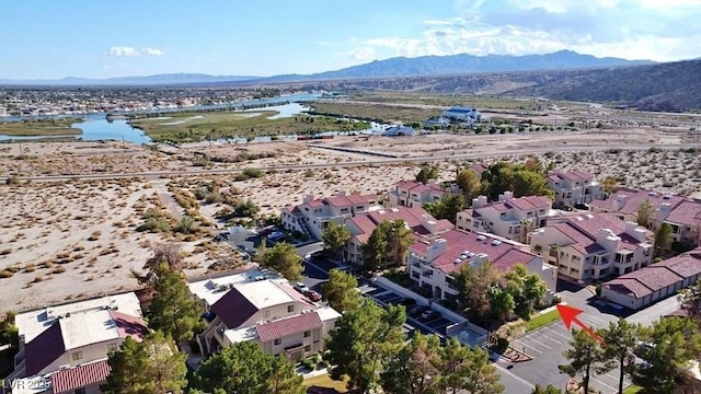 drone / aerial view with a residential view and a water and mountain view