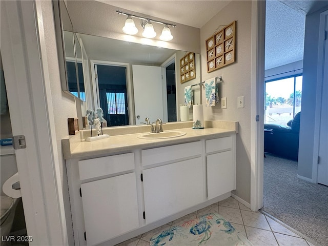 bathroom featuring tile patterned flooring, vanity, and baseboards