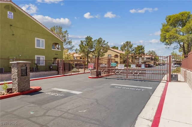 7950 W Flamingo Rd Unit 2066, Las Vegas, NV 89147 - view of asphalt street featuring a gate, a gated entry, and curbs