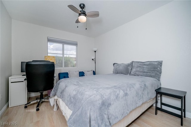 bedroom with wood finished floors, a ceiling fan, and baseboards