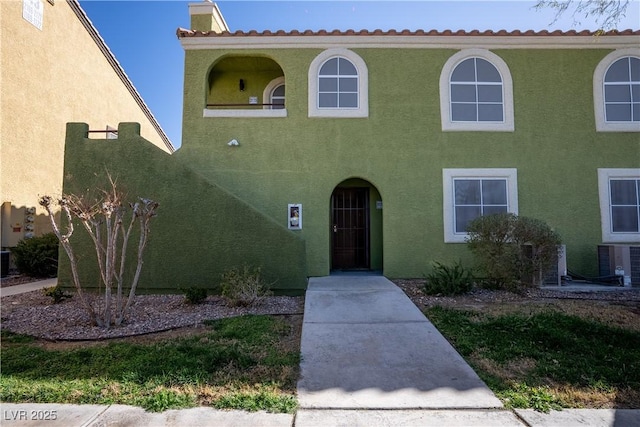 view of front of property featuring stucco siding and central air condition unit