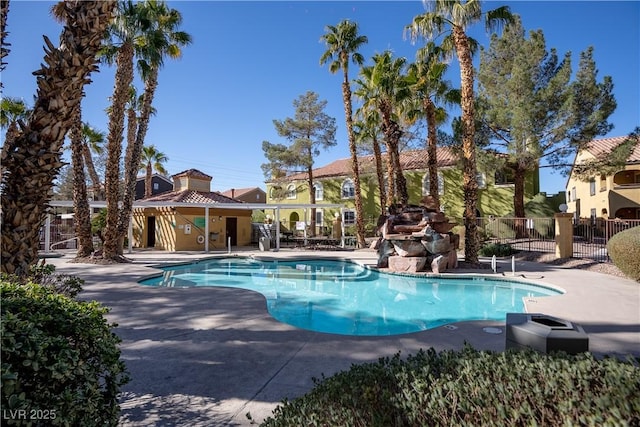 pool with fence and a patio area