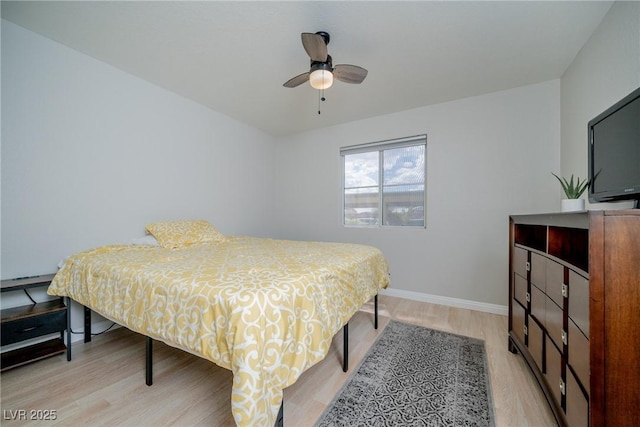 bedroom with baseboards, light wood-type flooring, and ceiling fan