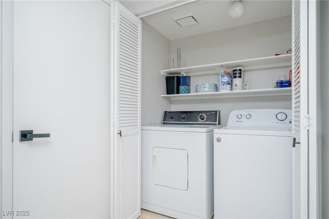 laundry room featuring washing machine and clothes dryer and laundry area