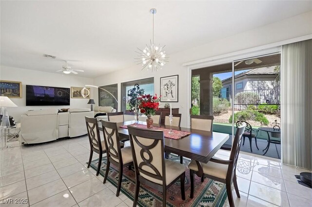 dining area featuring light tile patterned floors, visible vents, and ceiling fan with notable chandelier