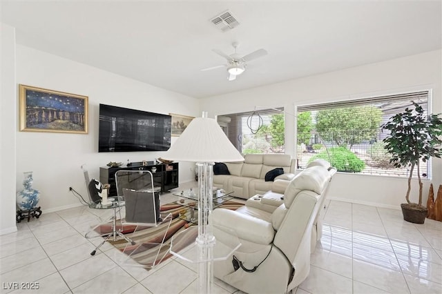 living room featuring baseboards, visible vents, ceiling fan, and light tile patterned flooring