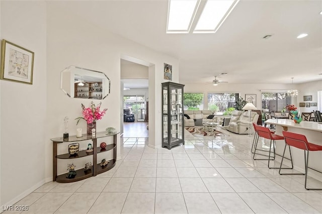 interior space featuring light tile patterned floors, a notable chandelier, visible vents, and baseboards