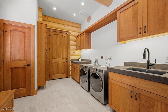 laundry area featuring cabinet space, washer and dryer, rustic walls, and recessed lighting