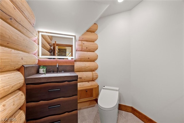 half bath featuring vanity, toilet, tile patterned floors, baseboards, and log walls