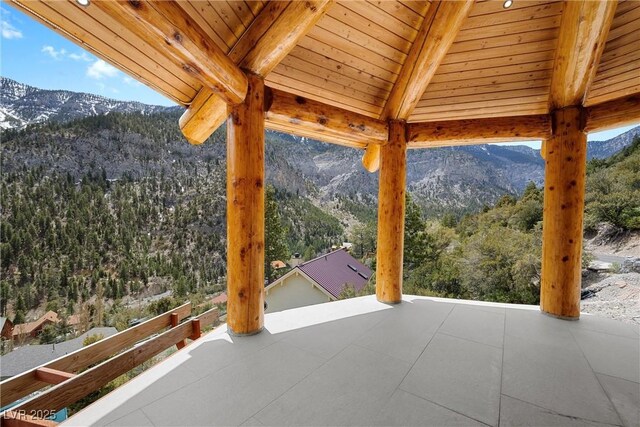 view of patio featuring a view of trees and a mountain view