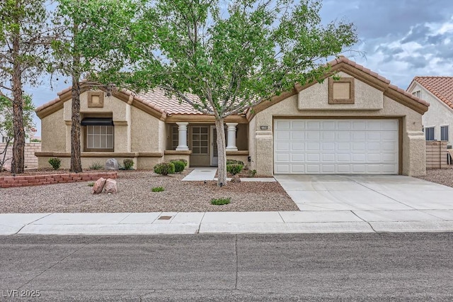 view of front facade with driveway, stucco siding, an attached garage, and a tile roof