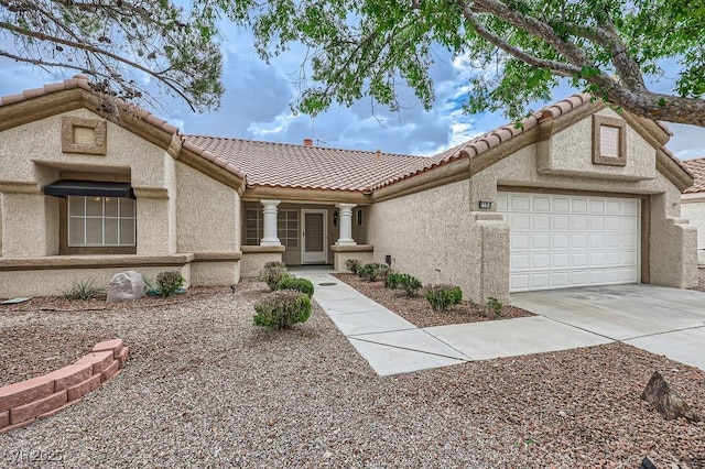 ranch-style house featuring an attached garage, a tiled roof, stucco siding, and concrete driveway