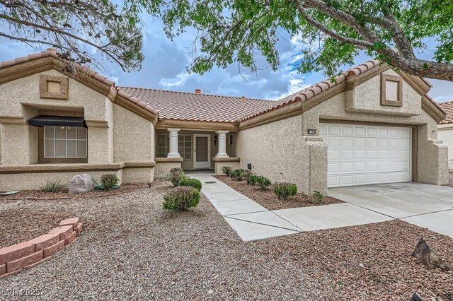 3104 Archwood Way, Las Vegas, NV 89134 - view of front of home with a tile roof, stucco siding, an attached garage, and concrete driveway
