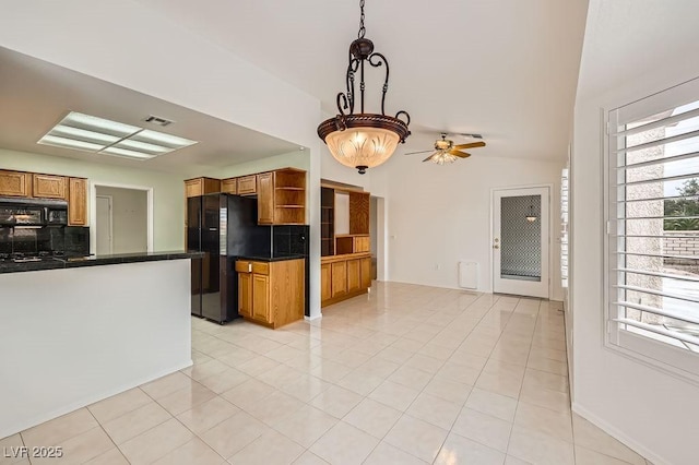 kitchen featuring brown cabinets, open shelves, black appliances, visible vents, and dark countertops