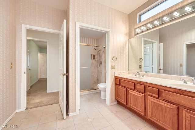 bathroom featuring wallpapered walls, toilet, a stall shower, and a sink