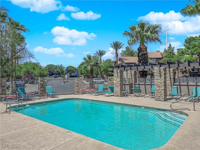 pool featuring a pergola, fence, and a patio area