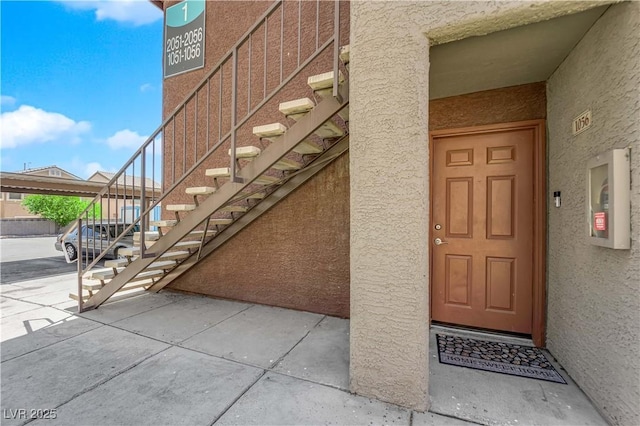 property entrance featuring stucco siding